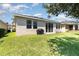 Backyard featuring well-maintained lawn, and a covered grill, perfect for outdoor relaxation and entertaining at 4737 Maple Park St, Orlando, FL 32811