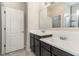 A clean bathroom with double sinks, white countertops, and a glass-enclosed shower at 4737 Maple Park St, Orlando, FL 32811