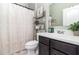 Bathroom featuring a modern vanity, dark cabinets, and stylish shelving with decorative accents at 4737 Maple Park St, Orlando, FL 32811