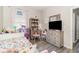 Cozy bedroom with a dresser, mirror, TV, and toys, creating a delightful and functional space at 4737 Maple Park St, Orlando, FL 32811