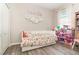 Charming bedroom features wood floors, a daybed with colorful bedding, and decorative wall art at 4737 Maple Park St, Orlando, FL 32811