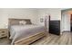 Bedroom with a wooden bed frame, wood-look flooring, and ensuite bathroom at 4737 Maple Park St, Orlando, FL 32811