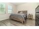 Bedroom with a wooden bed frame, wood-look flooring, and natural light from the window at 4737 Maple Park St, Orlando, FL 32811