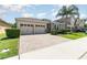 Beautiful home featuring a brick driveway and complemented by lush green landscaping at 4737 Maple Park St, Orlando, FL 32811