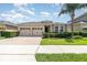 Charming single-story home featuring a well-manicured lawn and a two-car garage at 4737 Maple Park St, Orlando, FL 32811