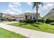 Beautiful home featuring a brick driveway and complemented by lush green landscaping at 4737 Maple Park St, Orlando, FL 32811