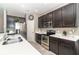 A well-lit kitchen with stainless steel appliances and white quartz countertops at 4737 Maple Park St, Orlando, FL 32811