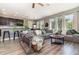 Open-concept living room featuring abundant natural light, wood floors and modern furnishings at 4737 Maple Park St, Orlando, FL 32811