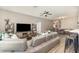 A spacious living room with a sectional sofa, ceiling fan, and modern decor at 4737 Maple Park St, Orlando, FL 32811