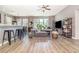Open-concept living room featuring abundant natural light, wood floors and modern furnishings at 4737 Maple Park St, Orlando, FL 32811