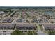 Aerial view of a neighborhood with townhomes, single-Gathering homes, and a scenic pond at 5119 Jones Rd, St Cloud, FL 34771