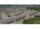 Aerial view of a neighborhood with townhomes and single-Gathering homes, featuring a community lake at 5119 Jones Rd, St Cloud, FL 34771