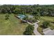 Aerial view of a home with a pool and lush backyard, complemented by a long driveway at 5119 Jones Rd, St Cloud, FL 34771