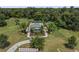 Aerial view of a home with a pool, surrounded by a lush green lawn and tropical landscaping at 5119 Jones Rd, St Cloud, FL 34771