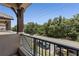 Balcony view with railing overlooking a street lined with trees on a clear day at 5119 Jones Rd, St Cloud, FL 34771