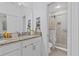 Modern bathroom featuring dual vanities, granite countertops, and a glass-enclosed shower at 5119 Jones Rd, St Cloud, FL 34771