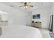 Bright bedroom with a tray ceiling, TV, and neutral walls and carpet at 5119 Jones Rd, St Cloud, FL 34771