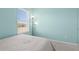 Bright bedroom featuring a window with blinds and light teal colored walls at 5119 Jones Rd, St Cloud, FL 34771