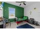 This bedroom has a green accent wall, window, TV, and a bed at 5119 Jones Rd, St Cloud, FL 34771