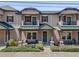 Charming townhouse featuring a cozy front porch and beautiful landscaping at 5119 Jones Rd, St Cloud, FL 34771