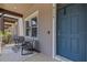 Relaxing front porch with seating and a blue door at 5119 Jones Rd, St Cloud, FL 34771
