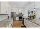 Well-lit kitchen with stainless steel appliances, granite counters, and wood floors at 5119 Jones Rd, St Cloud, FL 34771