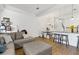 Bright open concept living room with a modern sofa, hardwood floors, and dining nook at 5119 Jones Rd, St Cloud, FL 34771