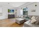 Spacious living room with hardwood floors, TV, and a comfortable sectional sofa at 5119 Jones Rd, St Cloud, FL 34771