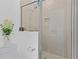 Clean and modern shower with neutral tile, glass doors, and built in niche at 5119 Jones Rd, St Cloud, FL 34771