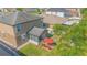 A landscaped backyard with a red patio umbrella and a screened in porch in this house aerial at 5151 Preserve Blvd, St Cloud, FL 34772