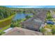 An aerial shot of a two-story home with lush green backyard, a lake view and a screened in porch at 5151 Preserve Blvd, St Cloud, FL 34772