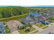 An aerial shot of a two-story home with lush green backyard, a lake view and a screened in porch at 5151 Preserve Blvd, St Cloud, FL 34772