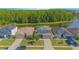 An aerial shot of a two-story home with lush green backyard, a lake view and a screened in porch at 5151 Preserve Blvd, St Cloud, FL 34772