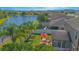 An aerial shot of a lush green backyard with patio furniture, a screened in porch and a lake view at 5151 Preserve Blvd, St Cloud, FL 34772