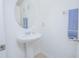 Clean half bathroom features a pedestal sink, tile floor, and modern fixtures at 5151 Preserve Blvd, St Cloud, FL 34772