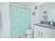 Bathroom featuring single vanity with granite countertop and koala-themed shower curtain, offering a cozy aesthetic at 5151 Preserve Blvd, St Cloud, FL 34772