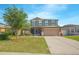 Charming two-story home with a screened in porch and a two car garage in a residential neighborhood at 5151 Preserve Blvd, St Cloud, FL 34772