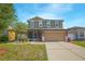 Charming two-story home with a screened in porch and a two car garage in a residential neighborhood at 5151 Preserve Blvd, St Cloud, FL 34772