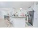 Bright kitchen features white cabinets, granite countertops, modern appliances, and tiled floors at 5151 Preserve Blvd, St Cloud, FL 34772