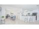 Bright open-concept living room featuring modern decor, tile floors, and a seamless connection to the dining area at 5151 Preserve Blvd, St Cloud, FL 34772