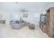 Spacious living room with comfortable seating, neutral tones, tile floors, and modern decor at 5151 Preserve Blvd, St Cloud, FL 34772