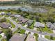 An aerial view of houses in a golf community near a scenic lake and mature trees at 5560 Squires Dr, Leesburg, FL 34748