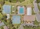Aerial view of community amenities, including tennis courts, a pool, and a clubhouse at 5560 Squires Dr, Leesburg, FL 34748