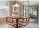 Breakfast nook area featuring a cozy round table and a view of the outdoor screened in lanai at 5560 Squires Dr, Leesburg, FL 34748