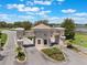 Royal Highlands entrance featuring a beautiful building and well-maintained grounds at 5560 Squires Dr, Leesburg, FL 34748