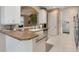 Kitchen with breakfast bar, stainless steel appliances, white cabinetry, and views to the living space at 5560 Squires Dr, Leesburg, FL 34748