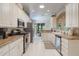 Bright kitchen with white cabinetry, stainless steel appliances, and a breakfast nook with outside views at 5560 Squires Dr, Leesburg, FL 34748