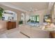 Open living room with neutral décor flowing to the kitchen and screened-in patio at 5560 Squires Dr, Leesburg, FL 34748