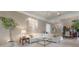 Bright living room with neutral tones, modern lighting, and a smooth transition to dining area at 5560 Squires Dr, Leesburg, FL 34748