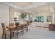 Open floor plan showcasing dining and living spaces with white tile, neutral colors, and plenty of light at 5560 Squires Dr, Leesburg, FL 34748